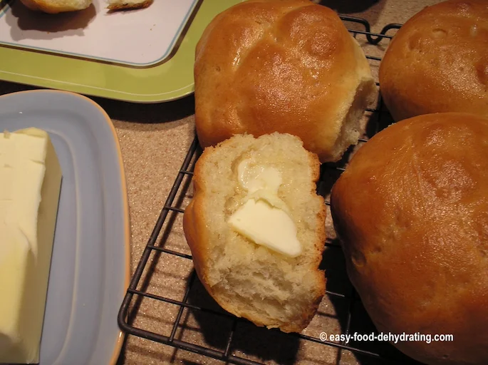 Bread buns on wire rack, one piece buttered and it was good! Bread buns on wire rack, one piece buttered