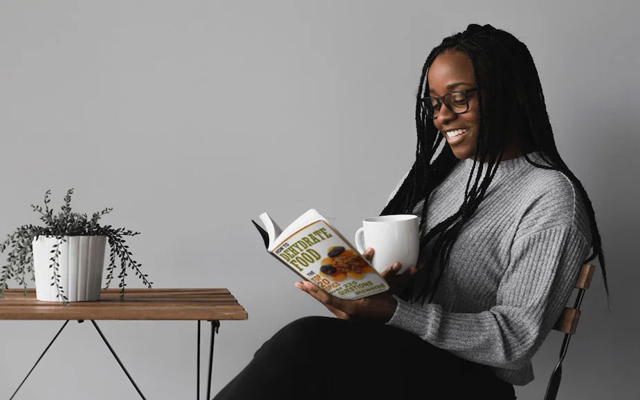 Woman reading How To Dehydrate Food, 225 Questions - Answered!