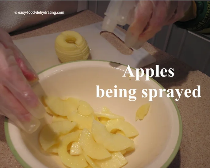 spraying apples with lemon juice to deter oxidation, plus I'm wearing latex gloves... spraying apples with lemon juice to deter oxidation
