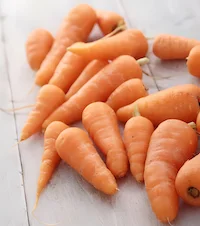 baby carrots in a pile baby carrots on a wooden table