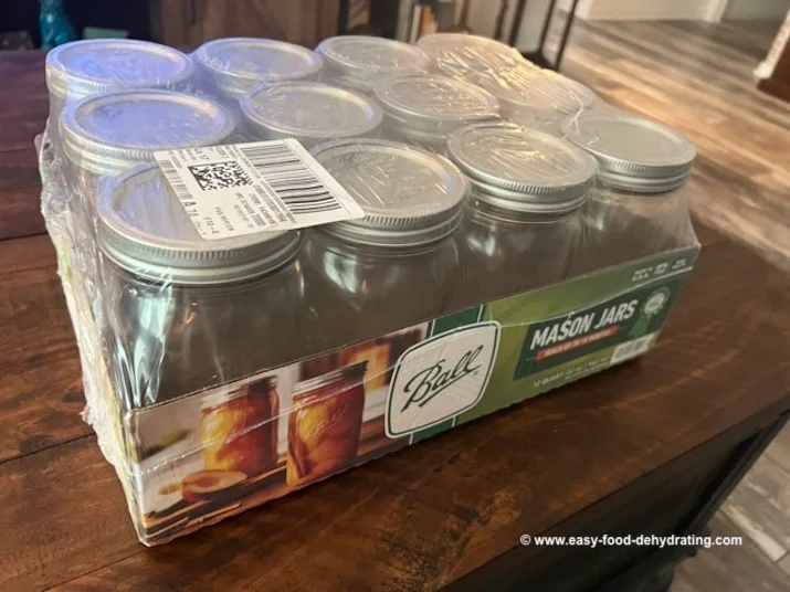 A 12-pack of Ball mason jars with lids, ideal for canning and storing dehydrated food