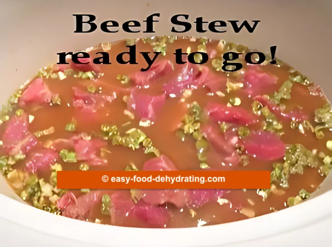 Beef Stew with dry ingredients, raw beef, and stock in a slow cooker. Beef Stew with dry ingredients, raw beef, and stock in a slow cooker.