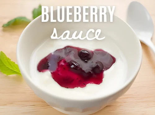 Blueberry sauce in a dish with plain yogurt Blueberry sauce in a dish with plain yogurt