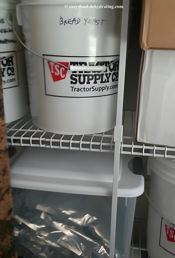 bins and buckets of dehydrated food and boxes on storage shelves