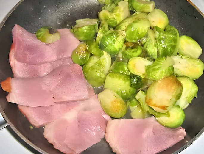 Brussels Sprouts frying in a pan with sweet country ham
