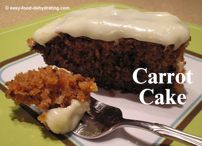 Carrot cake on a white and green plate with a piece of a fork