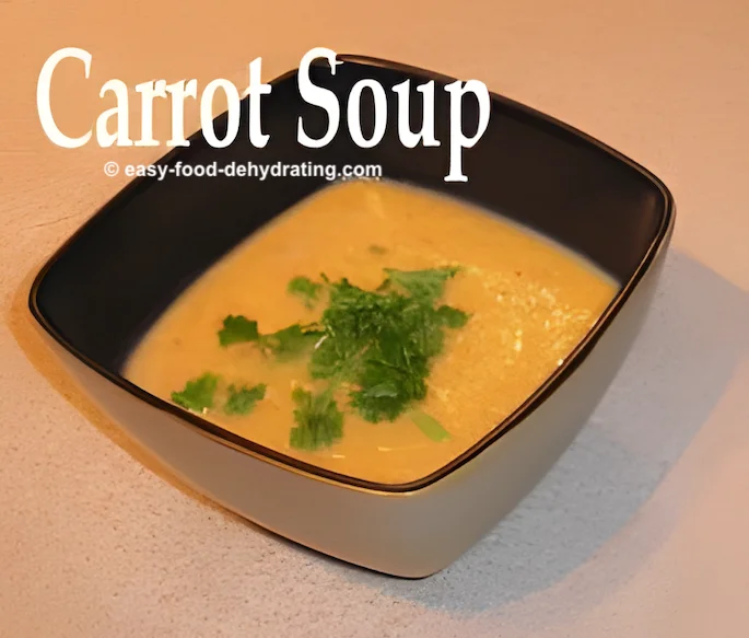 Carrot soup in a square bowl with chopped parsley