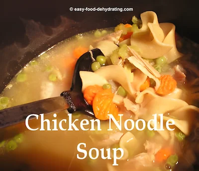 Chicken Noodle Soup in a pan with a black Teflon spoon
