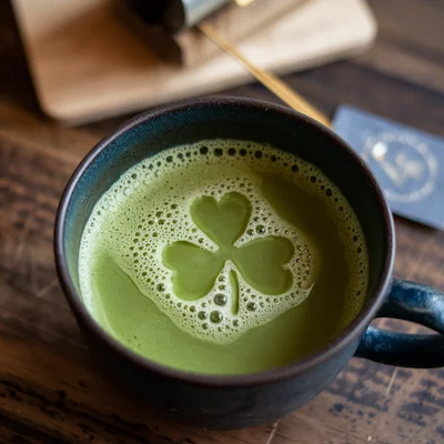 Cup of matcha tea with clover shaped froth Cup of matcha tea with clover shaped froth
