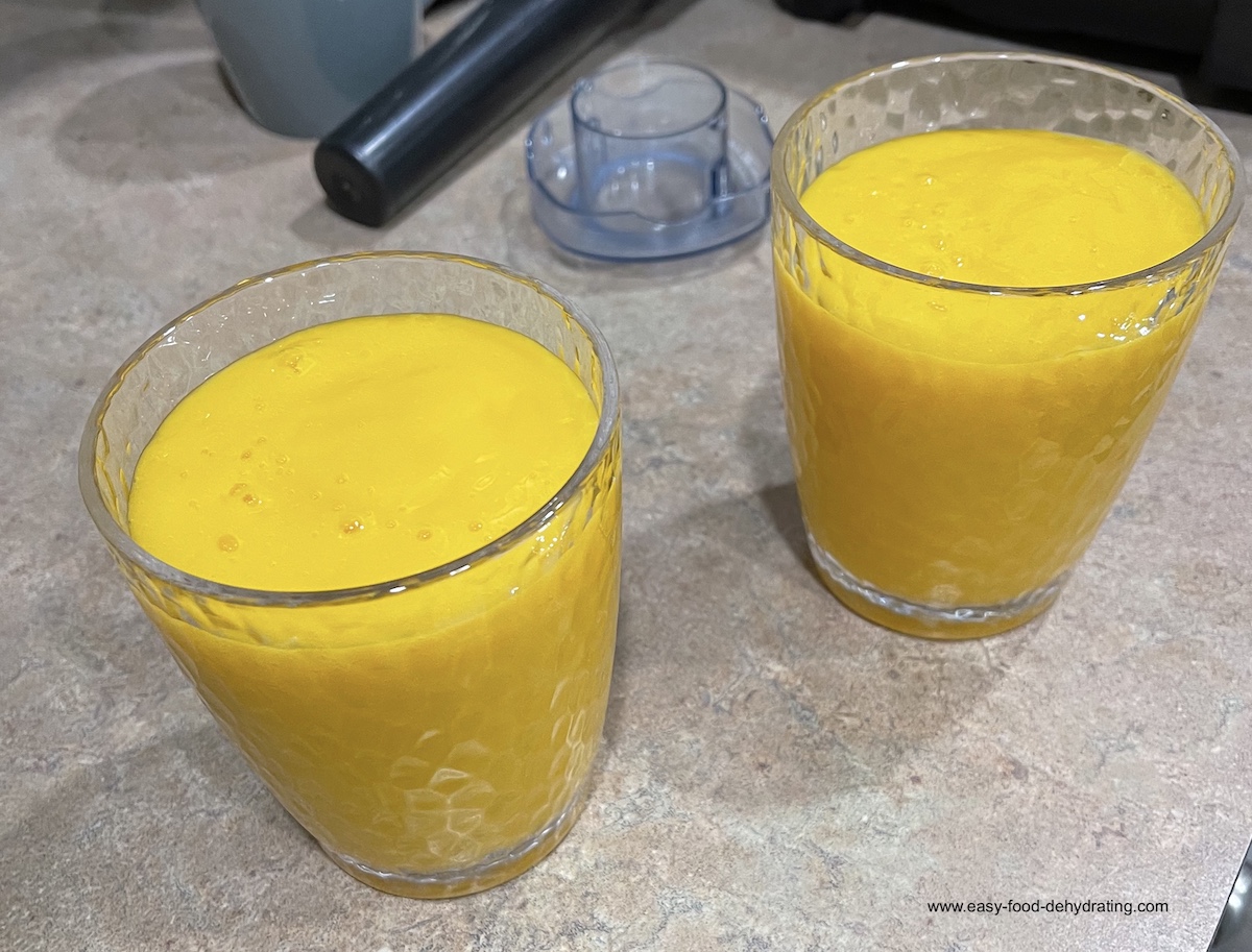 Two homemade mango smoothies in textured glasses, made from overripe mango and apple juice – Too Ripe to Dehydrate – July 2025 Two homemade mango smoothies in textured glasses, made from overripe mango and apple juice – Too Ripe to Dehydrate – July 2025