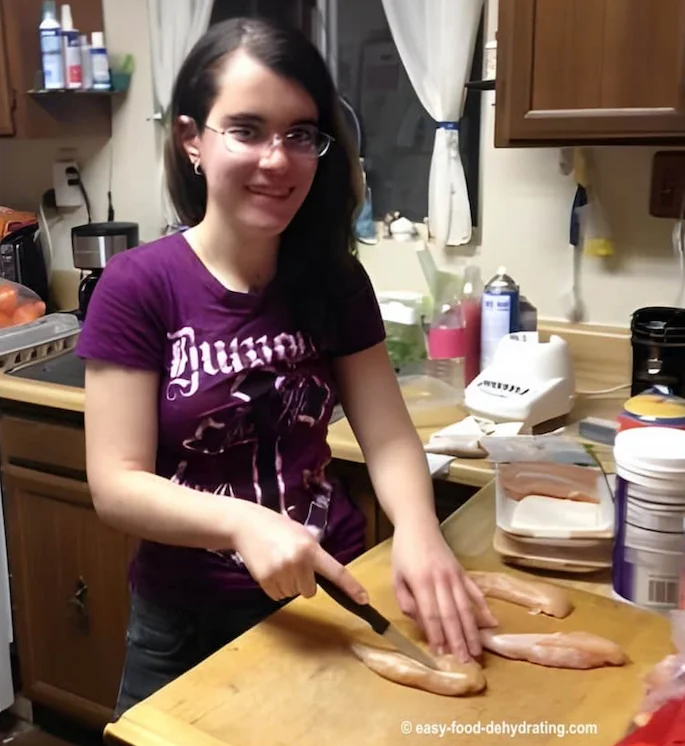 Jenna is slicing raw chicken to make jerky for her and her mom's dogs Jenna is slicing raw chicken to make jerky for her and her mom's dogs