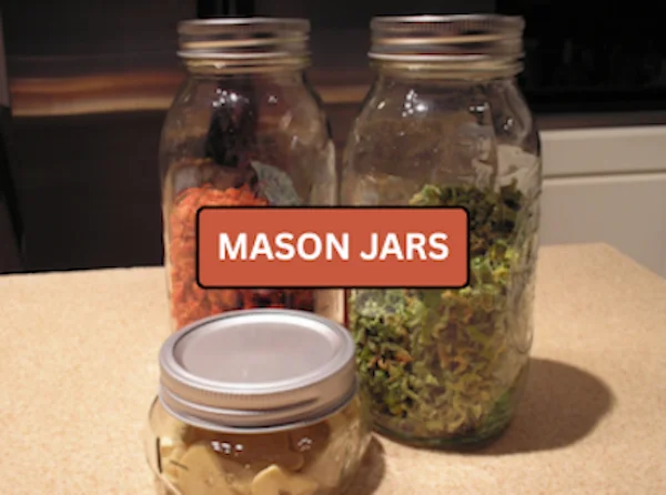 Mason jars filled with dehydrated vegetables and fruit on a countertop