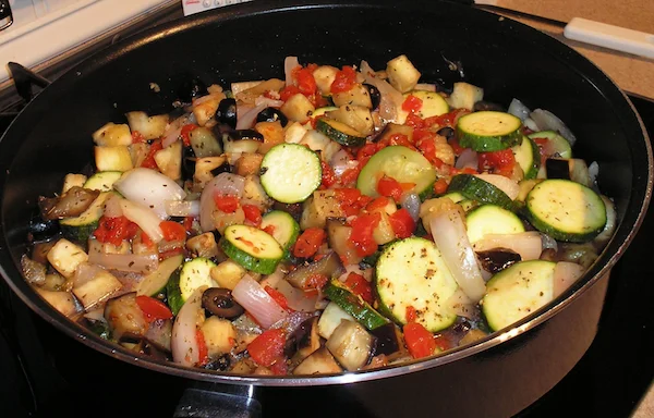 Colorful ratatouille with zucchini, peppers, onions, and eggplant in a skillet