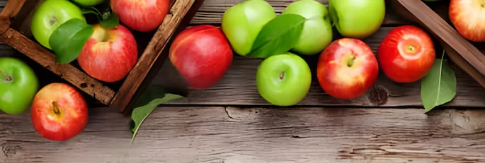 Green and red apples in wooden boxes on a wooden table Green and red apples in wooden boxes on a wooden table
