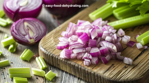 diced red onion and celery stalks on a cutting board diced red onion and celery stalks on cutting board